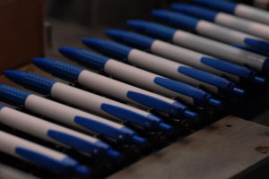 Blue & white colored pens lined up