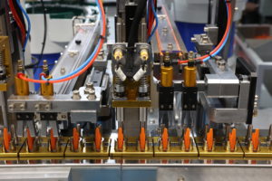 Orange pens lined up in a factory