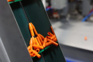 Close up of orange pens in a metal box