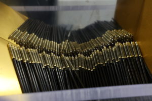 Bunch of black pens with a gold top