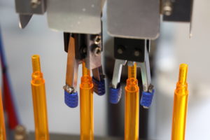 Orange pens lined up in a factory