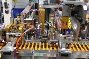 Orange pens lined up in a factory