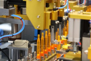 Orange pens lined up in a factory