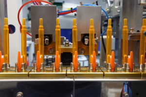 Orange pens lined up in a factory