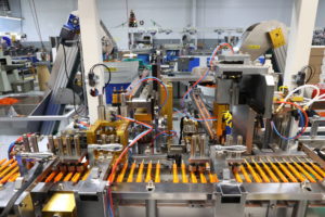factory machines with orange pens and blue and red wires