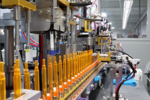 factory machines with orange pens and blue and red wires